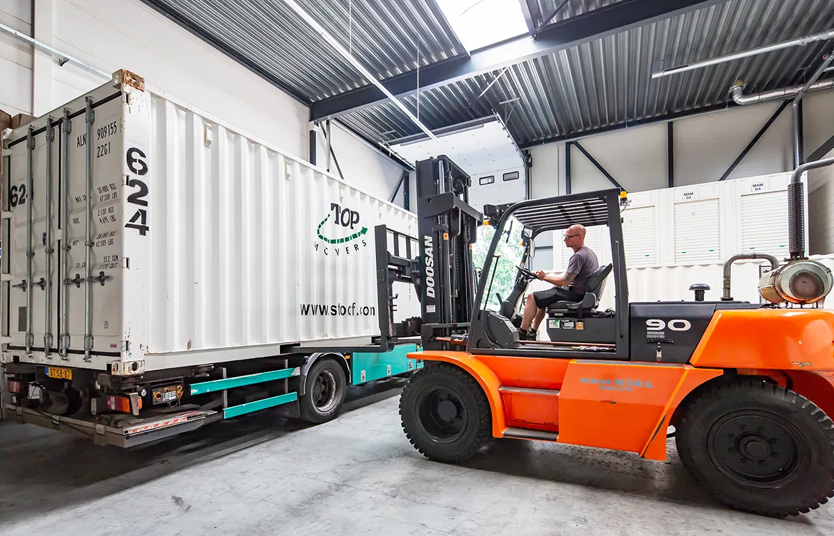 Opslagcontainer en heftruck in de opslaghal van De Bresser